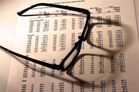 racnus (artist) - A Financial statement with a black frame eyeglasses. Fotografie stock - Microstock e Abbonamento, Codice: 400-04554603