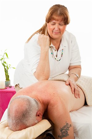 Mature man enjoys a relaxing massage from a professional masseuse. Photographie de stock - Aubaine LD & Abonnement, Code: 400-04554871