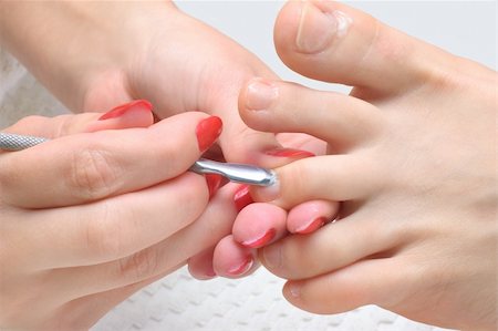 paint toe nails - body care series. pedicure applying - toe nails cleaning and moisturizing with special solution. Stock Photo - Budget Royalty-Free & Subscription, Code: 400-04555338