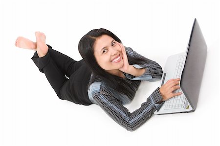 A young woman facing the camera while using her laptop. She is leaning on one of her hand. Stock Photo - Budget Royalty-Free & Subscription, Code: 400-04555503