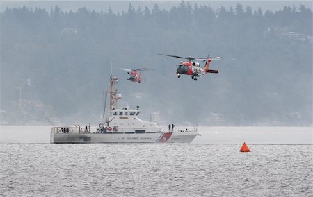 disaster and rescue - Coast guard performing it's rescue demonstration. Foto de stock - Super Valor sin royalties y Suscripción, Código: 400-04555638