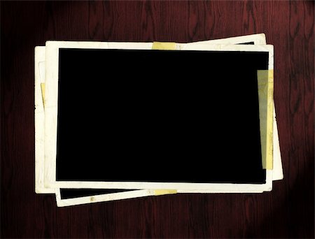 phecsone (artist) - Blank picture frames on dark wooden table. Stockbilder - Microstock & Abonnement, Bildnummer: 400-04556523