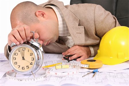 A businessman sleepy with architectural plans at desk Stock Photo - Budget Royalty-Free & Subscription, Code: 400-04556659