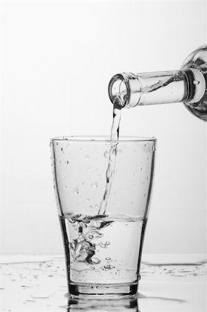 simsearch:400-05291556,k - glass of pouring water with reflection (white background) Stock Photo - Budget Royalty-Free & Subscription, Code: 400-04557714