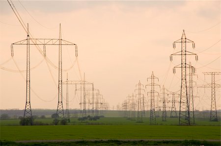 simsearch:400-04867577,k - Silhouette of the electricity pylon with cables and the blue sky Photographie de stock - Aubaine LD & Abonnement, Code: 400-04557900