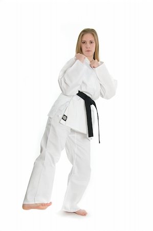 simsearch:400-04558215,k - Black belt female martial artist doing low kick from the side. Photographie de stock - Aubaine LD & Abonnement, Code: 400-04558214