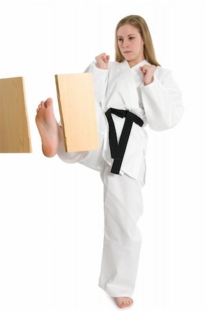 Black belt female martial artist doing board break. Stock Photo - Budget Royalty-Free & Subscription, Code: 400-04558217