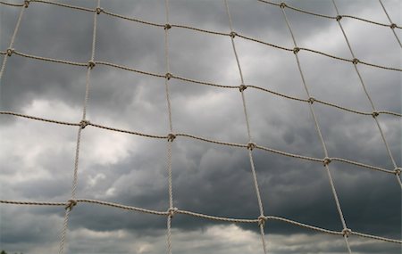 View of an impending storm through a soccer net Foto de stock - Royalty-Free Super Valor e Assinatura, Número: 400-04558434