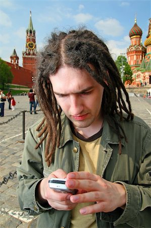 Young man with dreadlock hair and mobile phone. Stock Photo - Budget Royalty-Free & Subscription, Code: 400-04558714