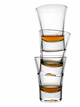 pour of liquor - A pile of three almost empty shots of whisky on white background Photographie de stock - Aubaine LD & Abonnement, Code: 400-04558755