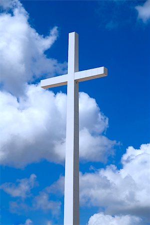 A huge religious cross on a beautiful partly cloudy blue sky Stock Photo - Budget Royalty-Free & Subscription, Code: 400-04559305