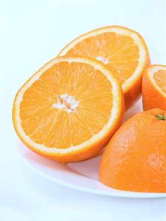dragunov (artist) - Sweet fresh oranges on the plate over white background Photographie de stock - Aubaine LD & Abonnement, Code: 400-04559377