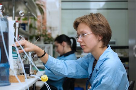 The young nice woman-scientist work with scientific instrument on a background scientific instruments Stock Photo - Budget Royalty-Free & Subscription, Code: 400-04559463