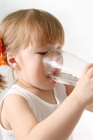 The small girl is drincking water from glas. Stock Photo - Budget Royalty-Free & Subscription, Code: 400-04559920