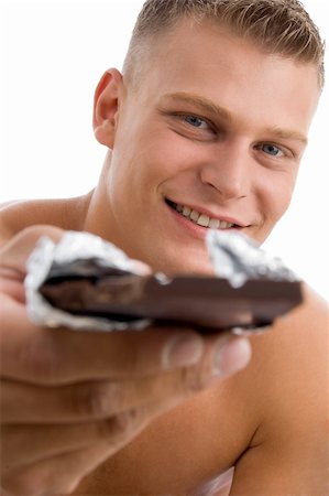 physical fit food - muscular man offering chocolate on an isolated background Stock Photo - Budget Royalty-Free & Subscription, Code: 400-04550898