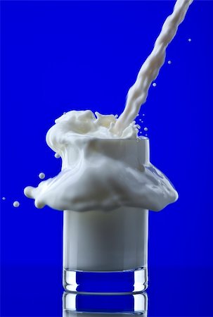 substitute - View of glass getting filled with milk on blue back Stock Photo - Budget Royalty-Free & Subscription, Code: 400-04552096