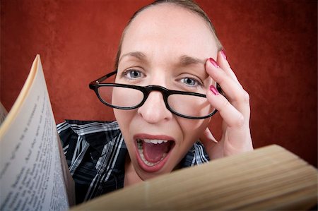 Screaming woman with big eyes and glasses reading a book. Stock Photo - Budget Royalty-Free & Subscription, Code: 400-04552175