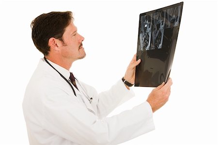 simsearch:400-05088212,k - Handsome doctor examining the results of and MRI scan. Stock Photo - Budget Royalty-Free & Subscription, Code: 400-04552594