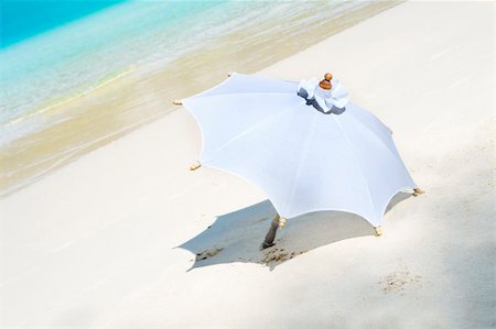 swim accessories - View of white parasol on sunny tropical beach Stock Photo - Budget Royalty-Free & Subscription, Code: 400-04553099