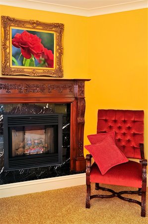 simsearch:400-06922170,k - Fireplace and red chair, image on the wall is my own Photographie de stock - Aubaine LD & Abonnement, Code: 400-04553228