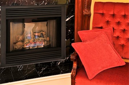 Fireplace and red chair in living room Stock Photo - Budget Royalty-Free & Subscription, Code: 400-04553229