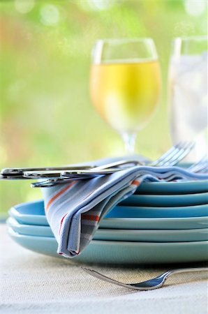 simsearch:400-05178995,k - Table setting with stack of plates and cutlery Stock Photo - Budget Royalty-Free & Subscription, Code: 400-04553275