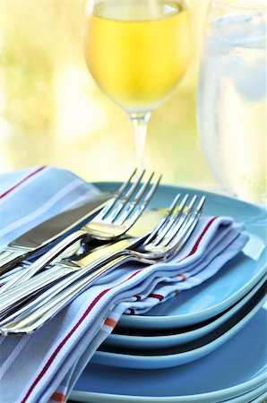 simsearch:400-05178995,k - Table setting with stack of plates and cutlery Stock Photo - Budget Royalty-Free & Subscription, Code: 400-04553276