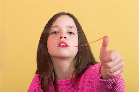 funny pictures people chewing gum - Young girl stretching a chewing gum from her mouth Stock Photo - Budget Royalty-Free & Subscription, Code: 400-04564123