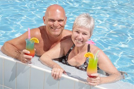attractive couple relaxing by the pool enjoying summer holidays Stock Photo - Budget Royalty-Free & Subscription, Code: 400-04564476