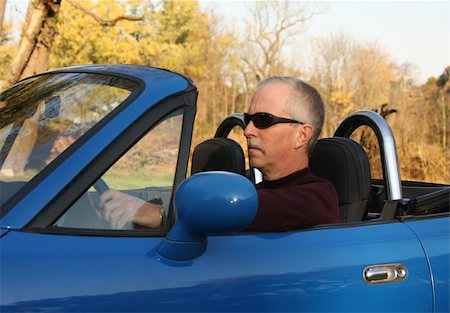 simsearch:628-03201079,k - Middle-aged man in a blue convertible sports car Stock Photo - Budget Royalty-Free & Subscription, Code: 400-04564772