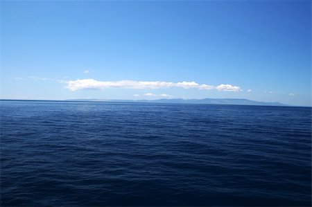 Perfect Blue Sea with coast on horizon Stock Photo - Budget Royalty-Free & Subscription, Code: 400-04565984