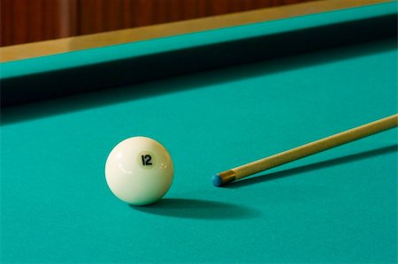 simsearch:400-04478467,k - The white billiard-ball number 12 and wood cue on a green table Stock Photo - Budget Royalty-Free & Subscription, Code: 400-04566294