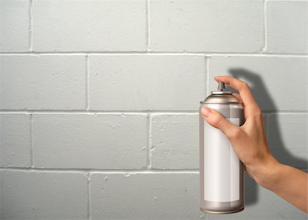 female hand using a spray cannister on a wall Foto de stock - Super Valor sin royalties y Suscripción, Código: 400-04566726