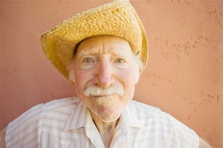 Senior Citizen Man with a Funny Expression Wearing a Straw Cowboy Hat Stock Photo - Budget Royalty-Free & Subscription, Code: 400-04567210