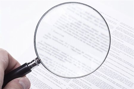 Hand holding a magnifying glass, showing the confusing fine print of a legal contract. Photographie de stock - Aubaine LD & Abonnement, Code: 400-04567823