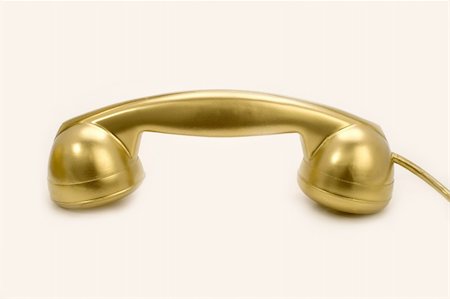 The telephone of gold colour on a white background. Stockbilder - Microstock & Abonnement, Bildnummer: 400-04568255