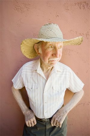 Senior Citizen Man Wearing a Straw Cowboy Hat Looks Off Stock Photo - Budget Royalty-Free & Subscription, Code: 400-04568364