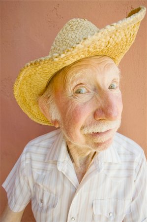 Senior Citizen Man with a Funny Expression Wearing a Straw Cowboy Hat Stock Photo - Budget Royalty-Free & Subscription, Code: 400-04568363