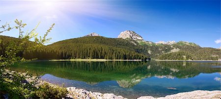 panorama of mountain lake with reflections and sunbeams Foto de stock - Super Valor sin royalties y Suscripción, Código: 400-04569567