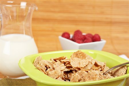 simsearch:400-04416748,k - A bowl of cornflakes, milk and raspberries on bamboo mat. Shallow depth of field Stock Photo - Budget Royalty-Free & Subscription, Code: 400-04569576