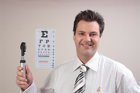 simsearch:400-07630065,k - Cheerful doctor, optometrist or ophthalmologist holding an  opthalmoscope. Foto de stock - Super Valor sin royalties y Suscripción, Código: 400-04560576