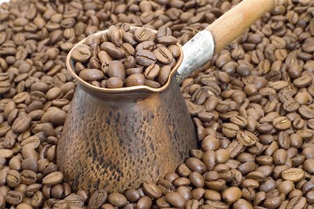 Turkish coffee pot on a background of coffee grains. Stockbilder - Microstock & Abonnement, Bildnummer: 400-04561565