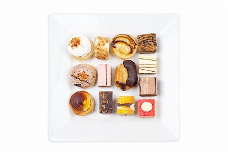 simsearch:400-04574251,k - Assortment of delicious cakes with soft shadow on white plate. Shallow depth of field Photographie de stock - Aubaine LD & Abonnement, Code: 400-04561589