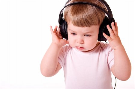 Little girl listening to music in the headphones. Studio shot, isolated on white background. Stock Photo - Budget Royalty-Free & Subscription, Code: 400-04561969