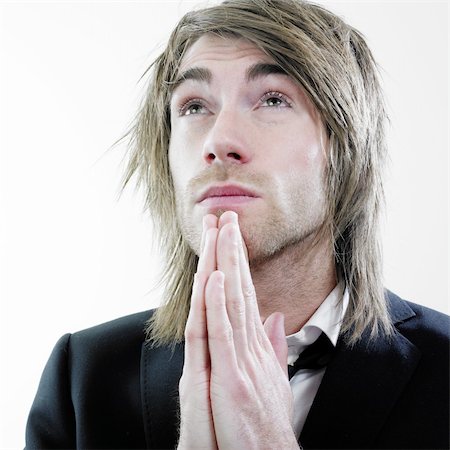 A portrait of a young man praying and looking up in he air. Foto de stock - Super Valor sin royalties y Suscripción, Código: 400-04562686