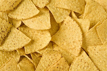 photo of people eating pretzels - Yellow triangular chips close up in all shot Stock Photo - Budget Royalty-Free & Subscription, Code: 400-04563815
