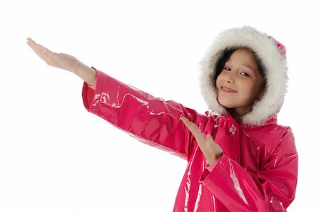 raincoat hood - Young girl in a pink raincoat with woolly hood advertising with both hands Stock Photo - Budget Royalty-Free & Subscription, Code: 400-04563887
