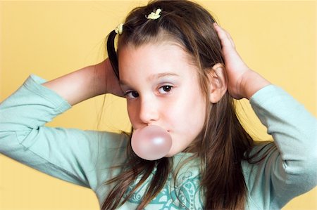 Young girl making a bubble from chewing gum and posing Stock Photo - Budget Royalty-Free & Subscription, Code: 400-04563881