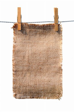 burlap canvas with lacerate edges hanging with wooden pegs, isolated on white Foto de stock - Royalty-Free Super Valor e Assinatura, Número: 400-04574161