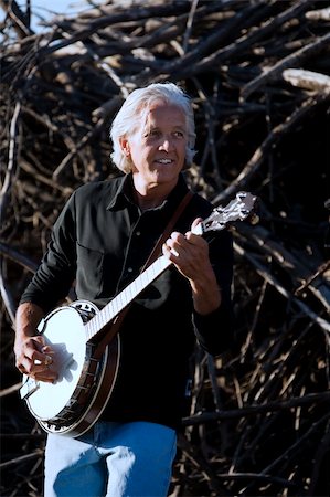 simsearch:400-05080507,k - Banjo Player in Front of a Big Pile of Wood Stock Photo - Budget Royalty-Free & Subscription, Code: 400-04574181